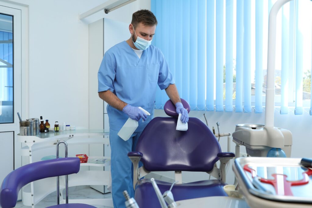 Dental assistant cleaning the chair