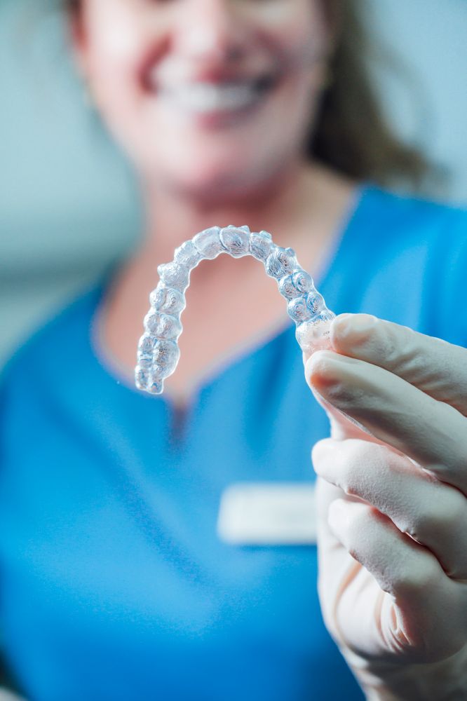 a dentist holding invisaligners