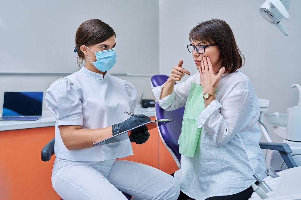 Woman and dentist discussing the same day dental implant