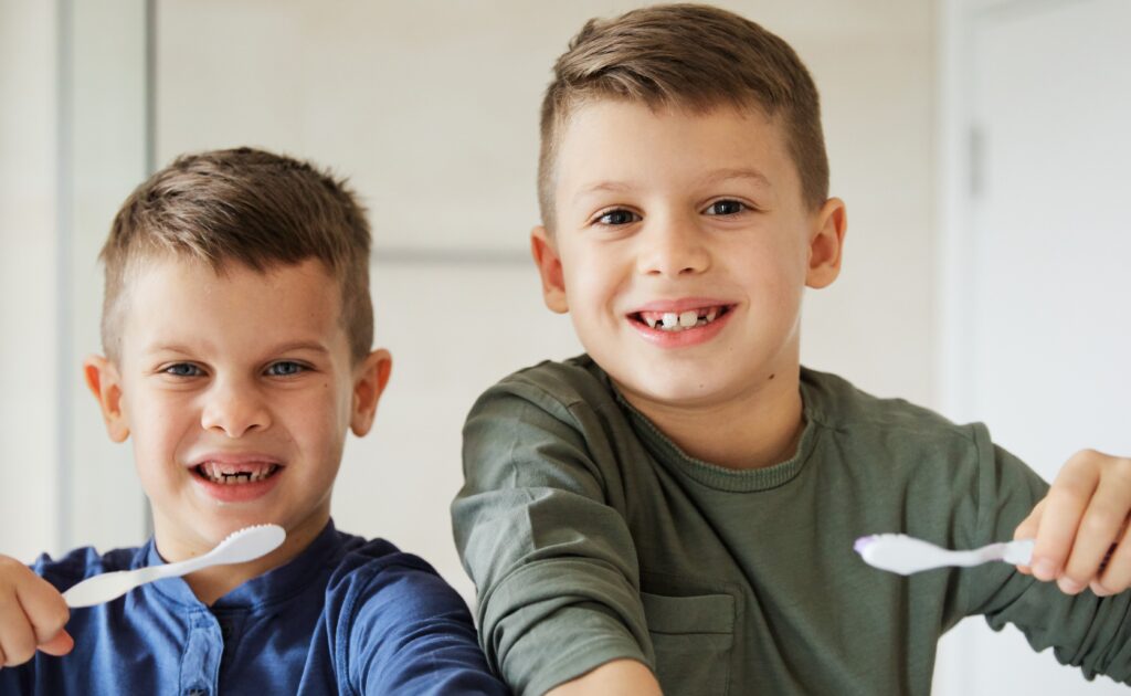 two smiling boys with their morning brush routine