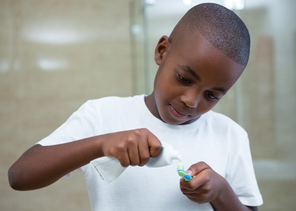 a kid of colour preparing for his brushing