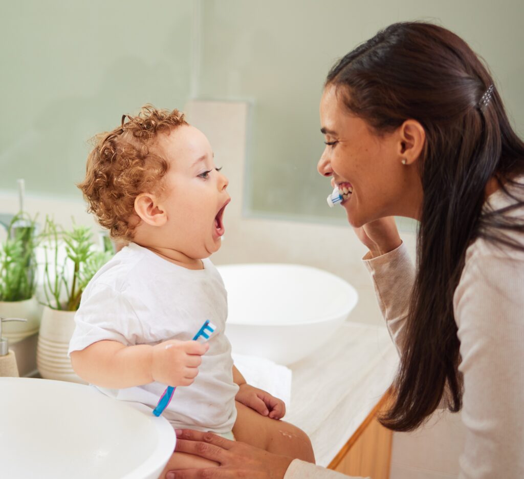 mother teaching her kids to brush
