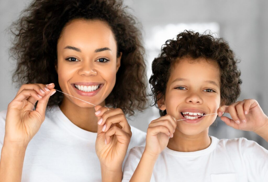 mother and son duo flossing 