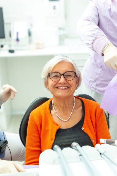 old smiling lady with her all-on-4 dental implants
