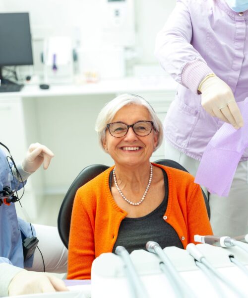 old smiling lady with her all-on-4 dental implants