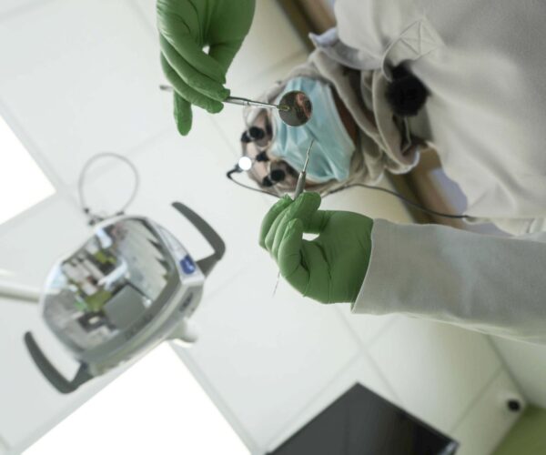 Dentist preparing for tooth extraction